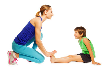 Happy boy stretching sitting on the floor with mom