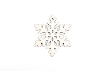 Gorgeous white wooden decoration - snowflake/ star. Adorable winter, Christmas, New Year, event decor made from solid wood. Isolated on white background. Top view. Closeup.
