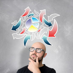 Young attractive perplexed geek man with brainstormaing arrow ov