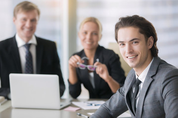 Fototapeta premium Group of business people and a smiling young man