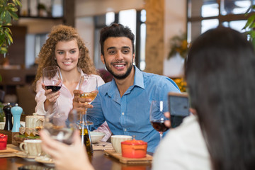 Young Business People Group Drink Wine Sitting Restaurant Table, Friends Hold Glasses Toasting Smiling Mix Race Men Women