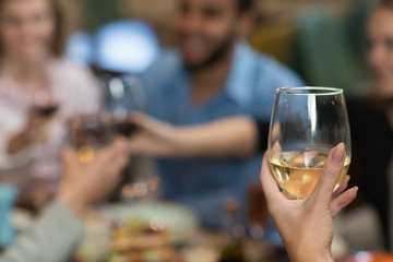 Young Business People Group Drink Wine Sitting Restaurant Table, Friends Hold Glasses Toasting Smiling Mix Race Men Women