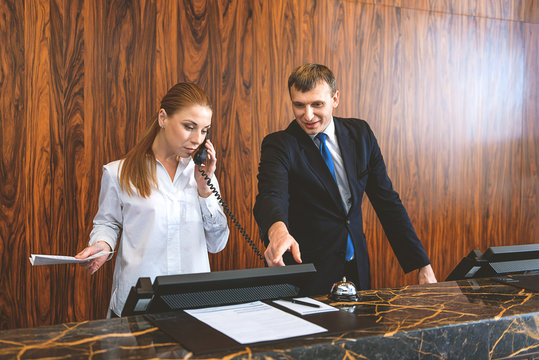 Two employees working at reception