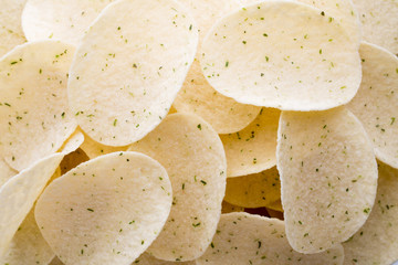 Close up potato chips on wood top view background.