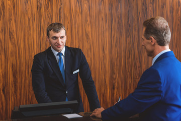 Mature man communicating to receptionist