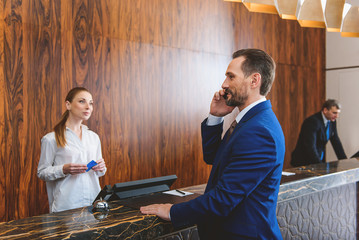 Presentable man standing at reception desk