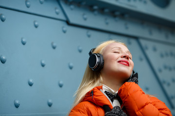 Woman in headphones listening music