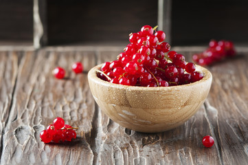Macro photo of red currant on the wooden table