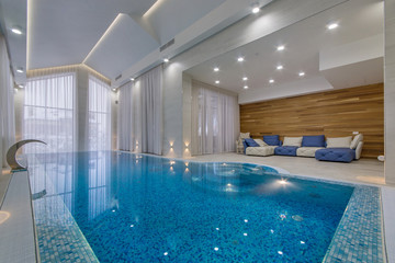 Luxury indoor pool with waterfall jet
