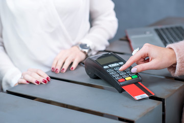 Entering pin code on the banking terminal at the store