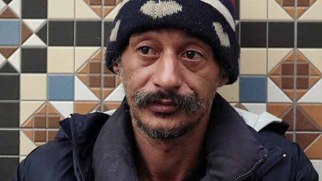 Close-up of an asian homeless begging for money on the street