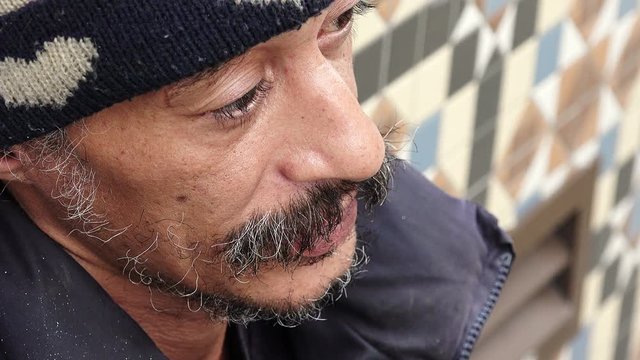 sad and lonely homeless waiting the charity in the street 