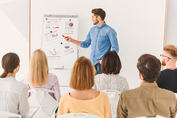 Smiling man presenting his idea to audience