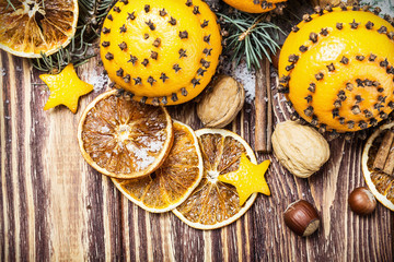 Christmas decorations and Christmas oranges on a wooden table and snow