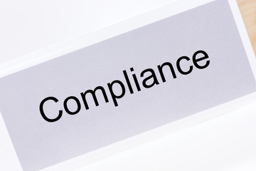 Office folder with the label compliance on white background