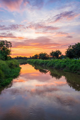 Obraz na płótnie Canvas sunrise reflection in a canal