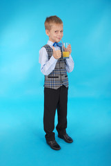 Boy drinking orange juice and showing thumb up © Akova
