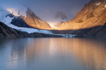 The rays of dawn over the mountain lake. Lake Laguna Torre. Patagonia. Argentina. © olenyok