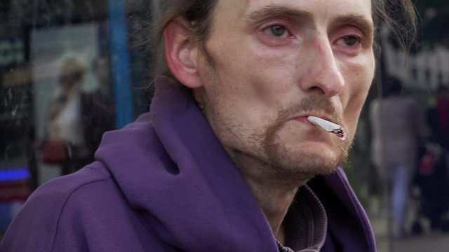 homeless smoking: asking for charity, waiting for the aid of people: asking food
