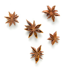 Star anise, scattered in a chaotic manner, isolated on white background