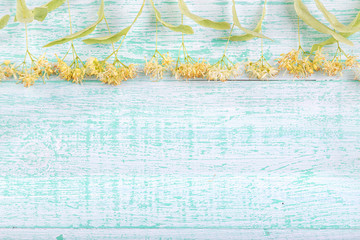 linden blossoms on a wooden background
