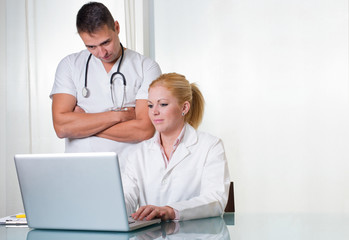 Couple of doctors working with computer space for text