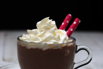 Hot chocolate cocoa with whipped cream on vintage wooden background, selective focus