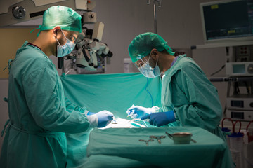 Two surgeons operating on a patient