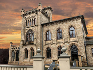 Old building in the Gothic architectural style autumn day  on the Sunset