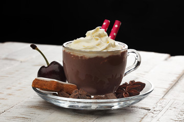 Hot chocolate cocoa with whipped cream on vintage wooden background, selective focus
