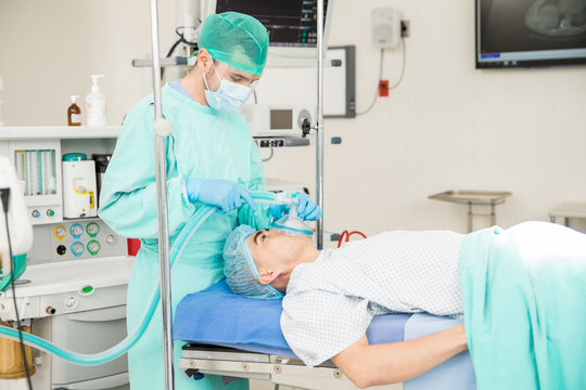 Anesthesiologist Working On A Patient