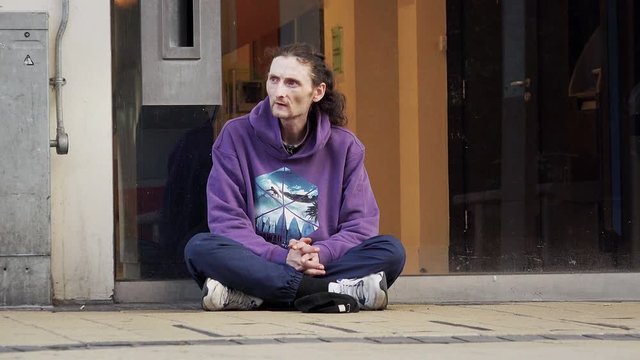 clochard on the ground asking charity: homeless, jobless,