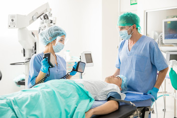 Doctors using defibrillator on patient