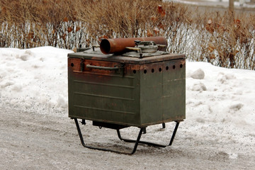 military soldier hunting metal stationary kitchen for preparing outdoor meals.