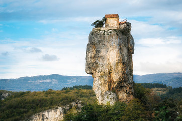 Katskhi pillar. Georgian landmarks. Man's monastery near the village of Katskhi. The orthodox church and the abbot cell on a rocky cliff. Imereti, Georgia. Georgian Meteora