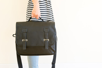 Woman carrying a black leather bag