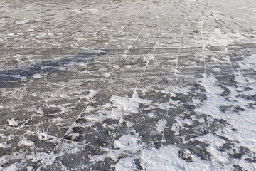 snow covered paving tiles, located on the street, the road after