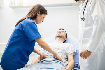 Doctor in scrubs examining a patient