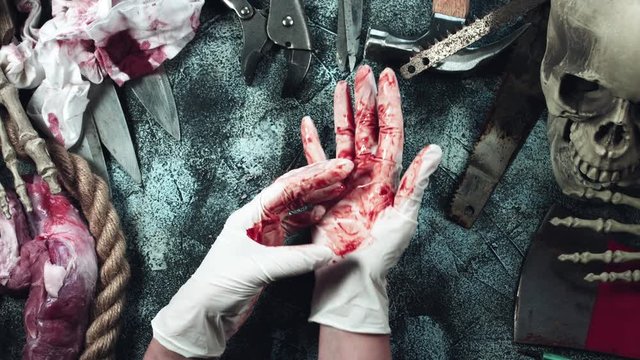 4k Horror and Bloody Composition of Hands taking off Bloody Gloves