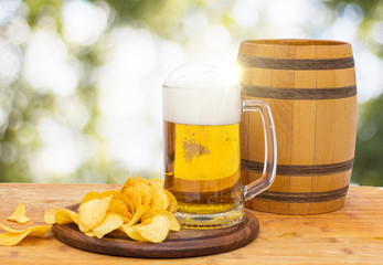 Fresh beer in the glass and chips.