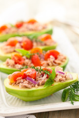 Stuffed avocado on tray.