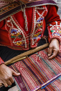 Quechua woman weaving a traditional textile, Cuzco, Peru 