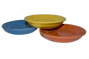 Clay plates of different colors on a white background
