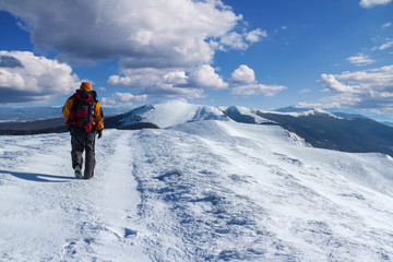 Fototapeta na wymiar Backpacker in winter mountains with beautiful landscape