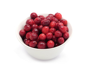 Cranberries in round white bowl isolated on white background indoor top view close up