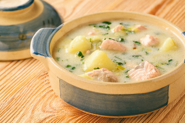 Potato soup with salmon, leek, sour cream and parsley.