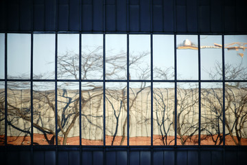 Abstrakte Spiegelungen im Fenster / Die abstrakte Spiegelung einer Hausfassade mit Fenstern in einer anderen Hausfassade mit Fenstern.