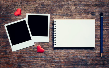 Blank photo frame, notebook, pencil and red heart for valentine