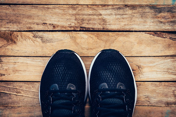 Black shoes casual and sneaker on wood background with space.