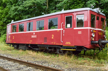 Fototapeta na wymiar Last compartment of an empty train stationed on a grassy track